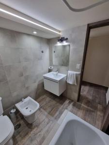 a bathroom with a white sink and a toilet at Lomas Schuss ARG41 in San Carlos de Bariloche