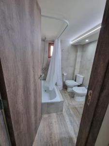y baño con aseo, bañera y lavamanos. en Lomas Schuss ARG41 en San Carlos de Bariloche