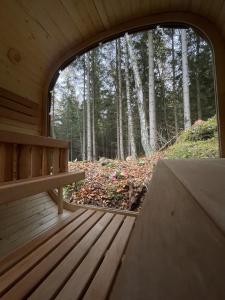 a porch of a cabin with a bench in the woods at Leśna Kąpiel in Karpacz
