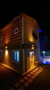 a brick building with a door at night at Villa Koyuncu in Dalaman