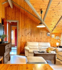 a living room with a couch and a table at Ferienhäuser Pannier I und oder II in Gartow