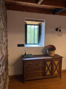 a wooden dresser in a room with a window at Rural Lambre by Miramar Stays in A Coruña +44 photos