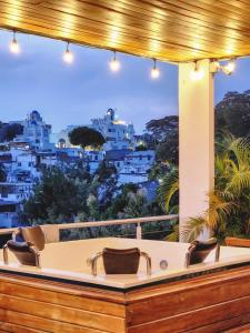a bath tub on a balcony with a view of the city at MIRADORES DEL PARAISO in Doradal