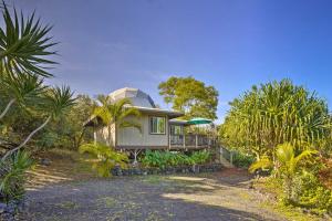 a house in the middle of a garden with palm trees at Peaceful Milolii Cottage with Ocean and Sunset Views! in Papa Bay Estates