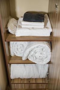 a group of folded towels in a closet at H Resort Hotel Vagharshapat Armenia in Vagharshapat