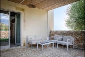 a patio with two chairs and a table at I Carusi Relais in Noto