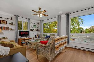 a living room with a couch and a ceiling fan at Cozy Waterfront Cottage, WiFi-Netflix-Dog Friendly in Lanark