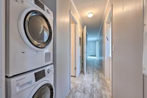 a laundry room with a washer and dryer next to a hallway at Cozy Cassopolis Retreat on Little Fish Lake! in Cassopolis