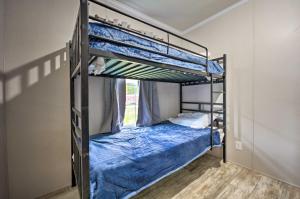 a bedroom with two bunk beds with blue sheets at Cozy Cassopolis Retreat on Little Fish Lake! in Cassopolis +28 photos