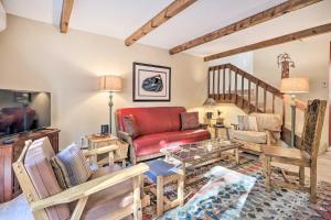 a living room with a red couch and wooden furniture at Large Santa Fe Townhouse with Private Patio! in Santa Fe