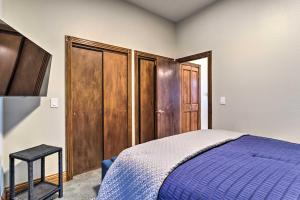 a bedroom with a blue bed and wooden cabinets at Updated Denver Townhome Less Than 1 Mi to St Josephs in Denver