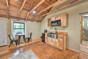 a kitchen with wooden cabinets and a table and chairs at Cassopolis The Cabin Retreat Lake Access! in Cassopolis