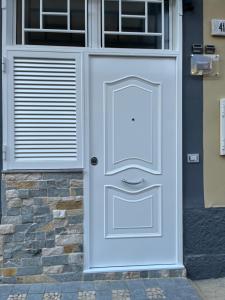 a white door on the side of a house at DG Sweet Home in Naples