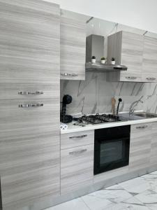 a kitchen with wooden cabinets and a stove top oven at DG Sweet Home in Naples