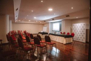 a room with a table and chairs and a podium at Casa Real Hotel in Salta
