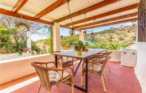 a table and chairs on a patio with a view at Awesome Home In Rincón De La Victoria in Rincón de la Victoria