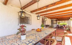 a dining room with a table and chairs at Awesome Home In Rincón De La Victoria in Rincón de la Victoria