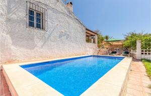 a swimming pool in front of a stone building at Awesome Home In Rincón De La Victoria in Rincón de la Victoria +30 photos