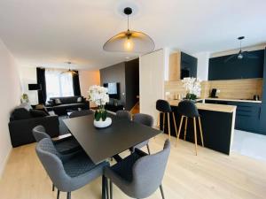 a kitchen and a living room with a table and chairs at Disneyland Dream 5 - Charmante Maison 10 pax in Chessy