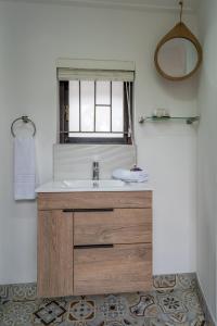 a bathroom with a sink and a window at Fairy Knowe Hotel in Wilderness