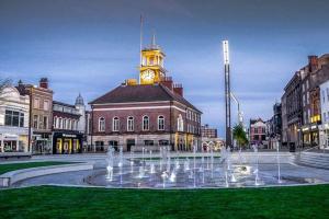 a clock tower on top of a building with a fountain at TimeChance Property Homz - Norton Road 1 Bed Apartment in Stockton-on-Tees