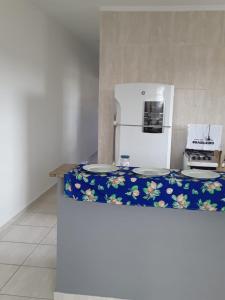 a kitchen with a counter top with a refrigerator at casa de praia campos in Itanhaém