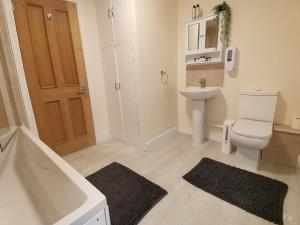 a bathroom with a white toilet and a sink at The Cross Inn in Hebden Bridge