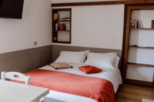 a bed with two pillows on it in a room at Residence Kalipè in Alagna Valsesia