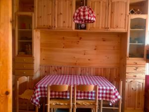 a kitchen with a table with a red and white checkered table cloth at Faggio Rosso in Filettino