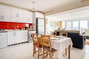 a kitchen and dining room with a table and chairs at BODRUM BURCU RESIDENCE, Magnificent Sea View, Cozy, Free Otopark, Free Wifi in Bodrum City