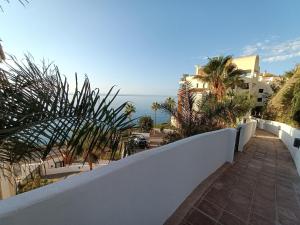 a balcony with a white fence and the ocean at El sol Espanol in Torrox Costa