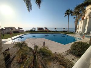 a swimming pool with a view of the ocean at El sol Espanol in Torrox Costa