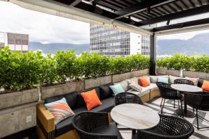 a patio with tables and chairs on a building at Mar Ipanema Hotel in Rio de Janeiro