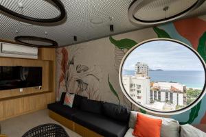 a living room with a couch and a round window at Hotel Astoria Ipanema in Rio de Janeiro