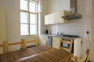 a small kitchen with a table and a stove at Central Living Apartments - Universität in Vienna