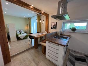 a kitchen with a sink and a desk in a room at Haus am Wanderweg in Melk