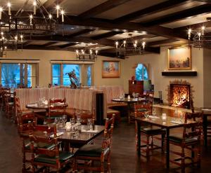 a dining room with tables and chairs and chandeliers at The Inn at Death Valley in Indian Village