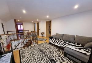 a living room with a couch and a zebra rug at Ciprians' Home in Săcele