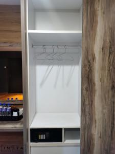 an empty refrigerator with its door open in a kitchen at Insta Hotel JB in Johor Bahru