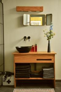 a bathroom vanity with a sink and a mirror at Himelsk in Koudum