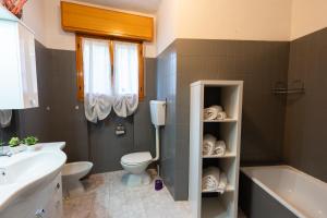 W łazience znajduje się toaleta, wanna i umywalka. w obiekcie Loft in Centro con Camino - Sestola w mieście Sestola