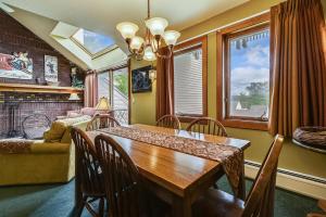 a dining room with a table and chairs and a couch at Sunrise Timberline I4 in Killington