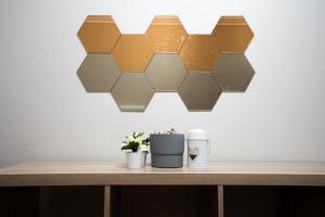 a table with a honeycomb light on a wall at Loft in Centro con Camino - Sestola in Sestola