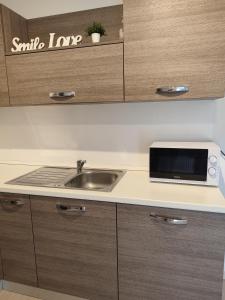 a kitchen with a sink and a microwave at Apartment Aria in Poreč