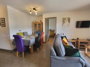 a dining room with a table and chairs at Plein Soleil Modern 3 bedroom apartment with stunning mountain views in Samoëns
