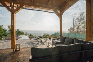 a living room with a couch on a wooden deck at Maringotka Olívie v Ivančicích in Ivančice