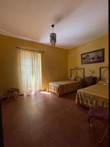 a hotel room with two beds and a window at Mirador del farmacéutico in Zahara de la Sierra