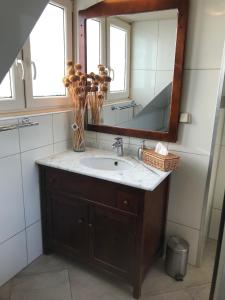 a bathroom with a sink and a mirror at ’t Huuske in Zonnemaire