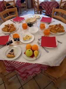 a table with plates of food and fruit on it at AFFITTACAMERE SAN BIAGIO in Genoa