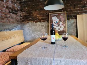 two glasses of red wine sitting on a table at Udahni prirodu in Raška